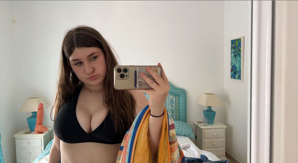 Selfie captures a large dildo in the background