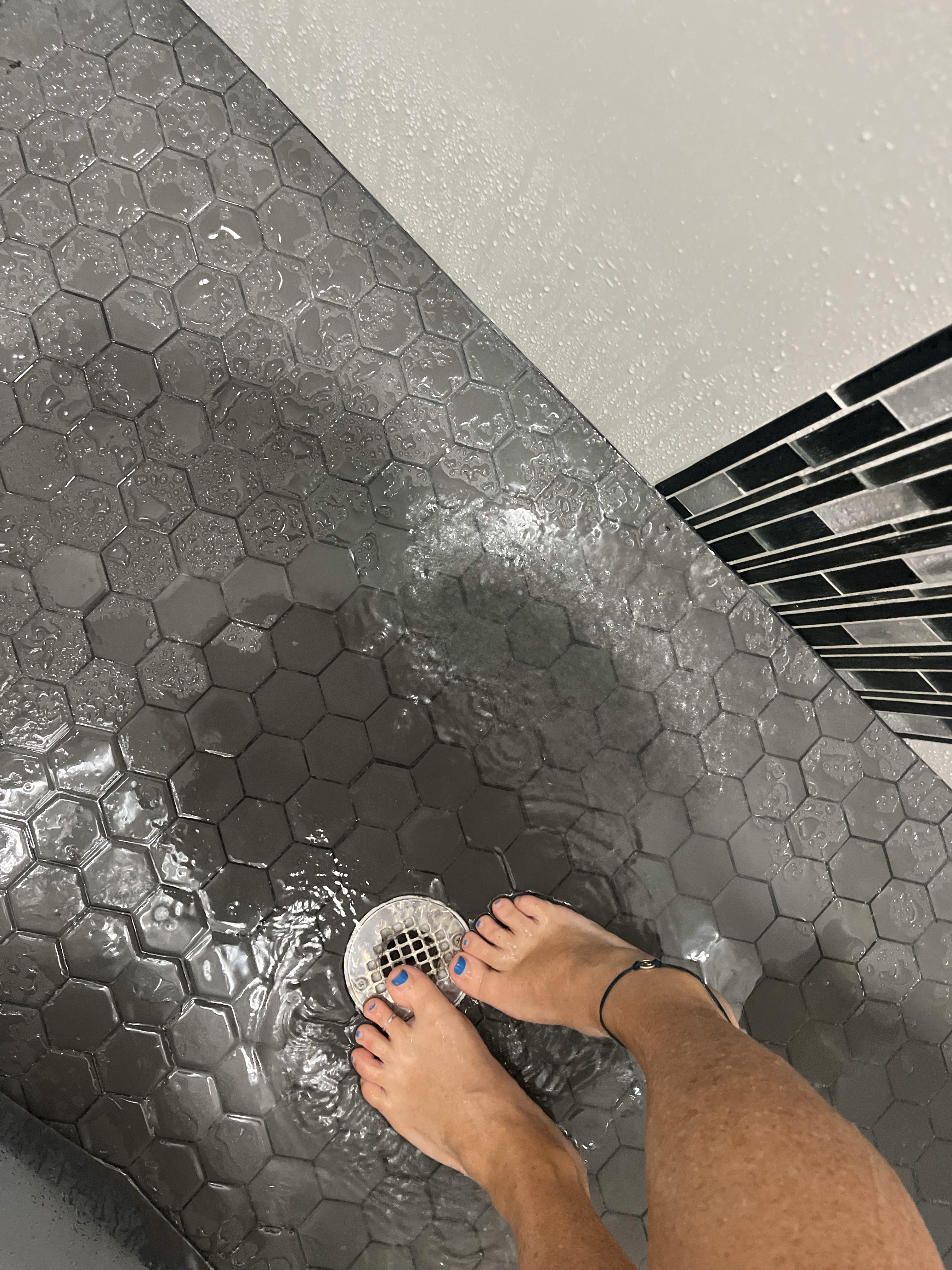 Kimchele showing feet in the shower