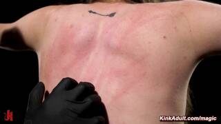 Slim slave Brooke Johnson restrained on wooden pony