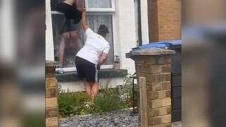 British women tits pop out while trying to climb into her house through her window