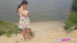 Naked girl masturbates on the river shore