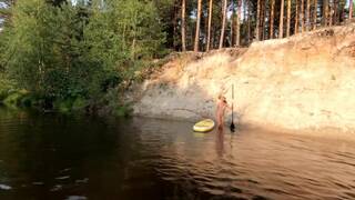 Tattooed Babe Strips and Swims on a SUP Board in the Forest River